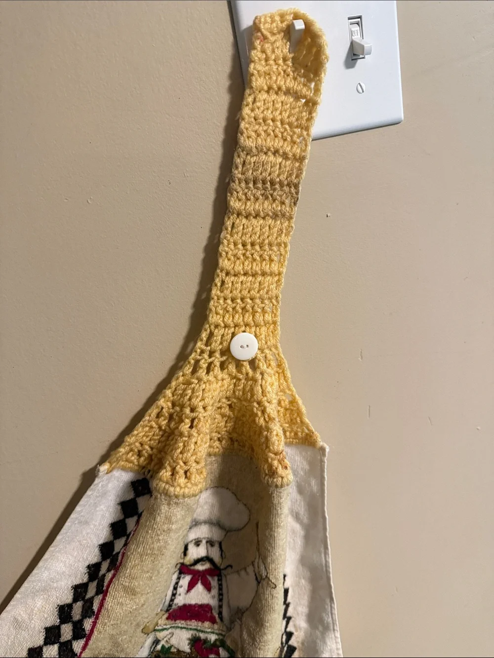 Vintage handmade yellow-topped crochet hanging kitchen towel featuring a chef